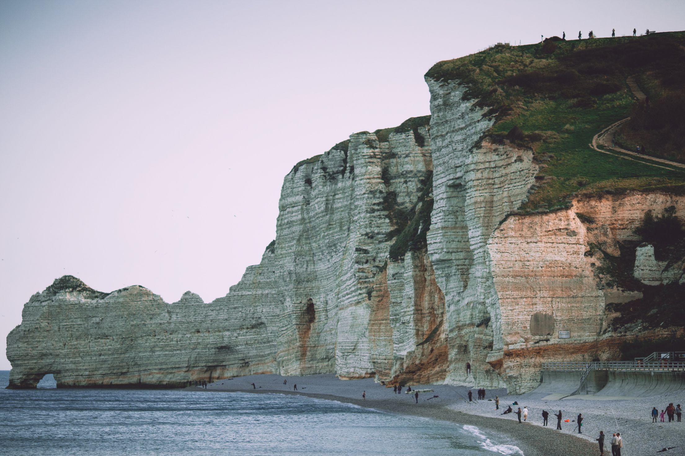 Beach and layered rock clif next to beach